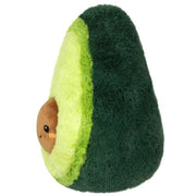 Side view of the Squishable Snacker Avocado plushie showing its soft layers and plush brown seed.