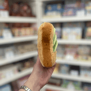Squishable Snacker Avocado Toast plush toy held in hand, side view