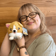 Squishable Snacker Baby Corgi plush being cuddled