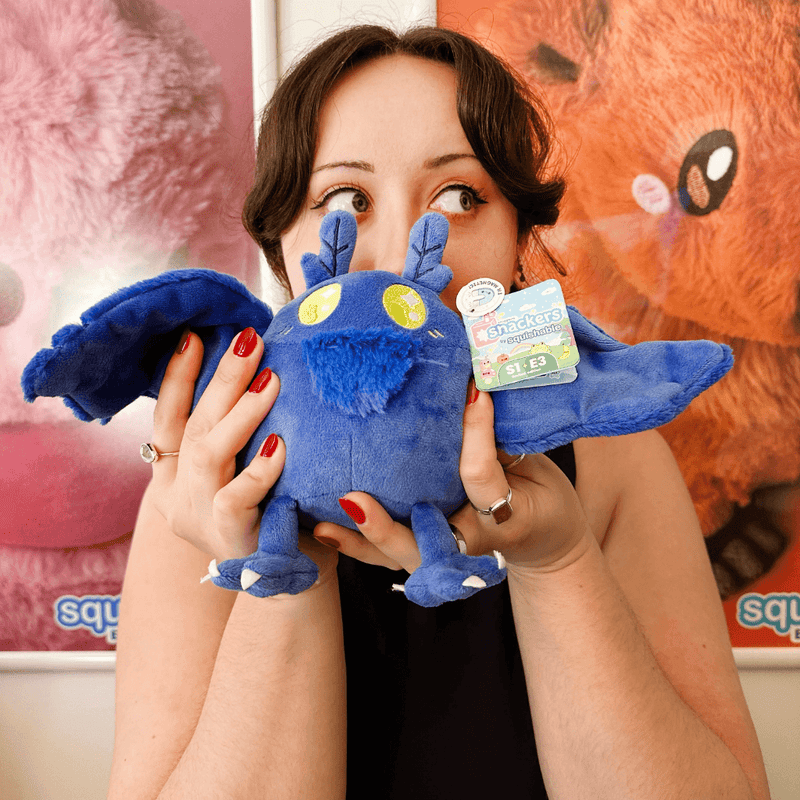 Squishable Snacker Blue Mothman plush being held