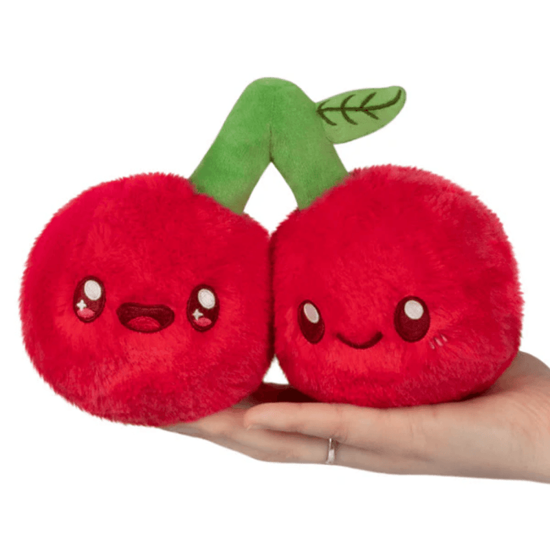 Front view of the Squishable Snacker Cherries plush toy showing two smiling red cherries joined by a green stem
