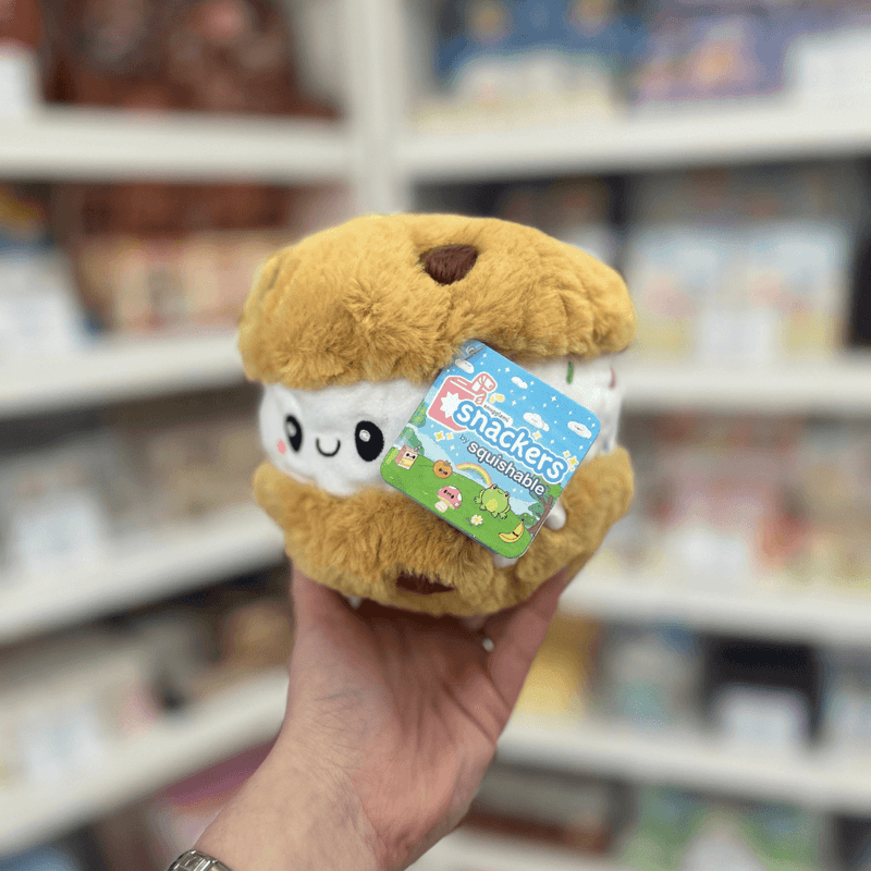 Squishable Snacker Cookie Ice Cream Sandwich plush toy held in hand with tag visible