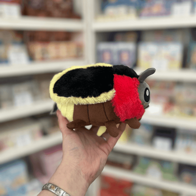 Squishable Snacker Firefly plush toy held in hand, side view