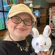 Squishable Snacker Fluffy Bunny plush toy being held for size comparison