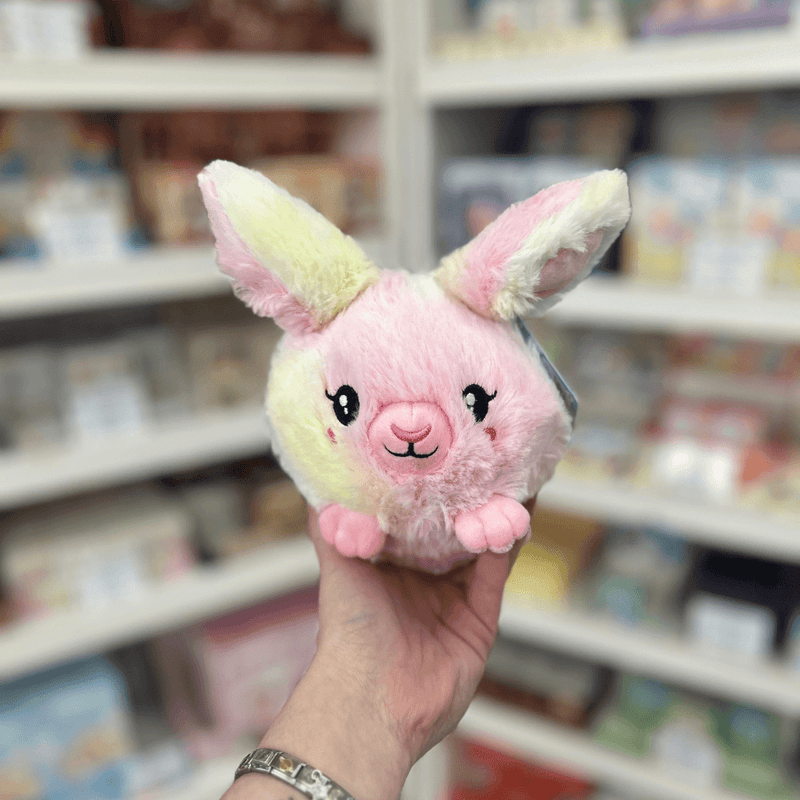Squishable Snacker Fluffy Bunny Tie Dye plush toy held in hand, front view