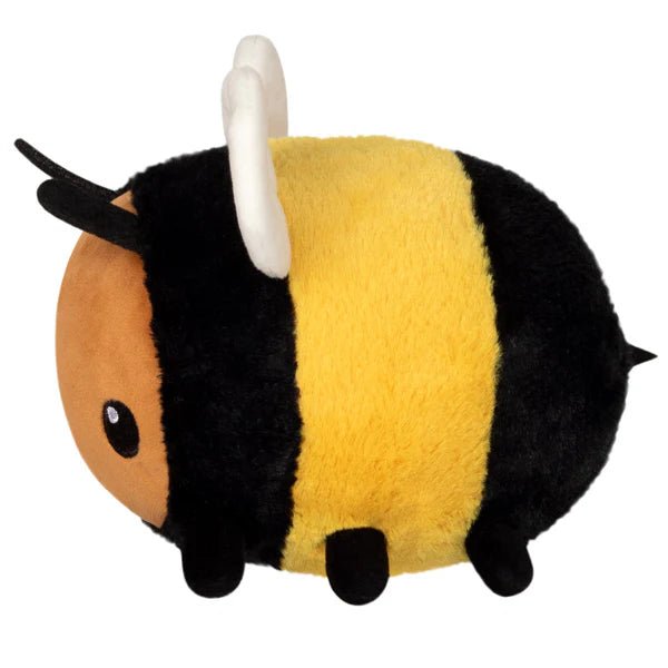 Side view of the Squishable Snacker Fuzzy Bumblebee plushie with yellow and black stripes, black legs, and tiny stinger.