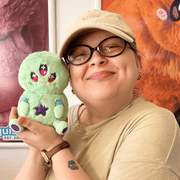 Squishable Snacker Green Alien plush toy being held for size comparison