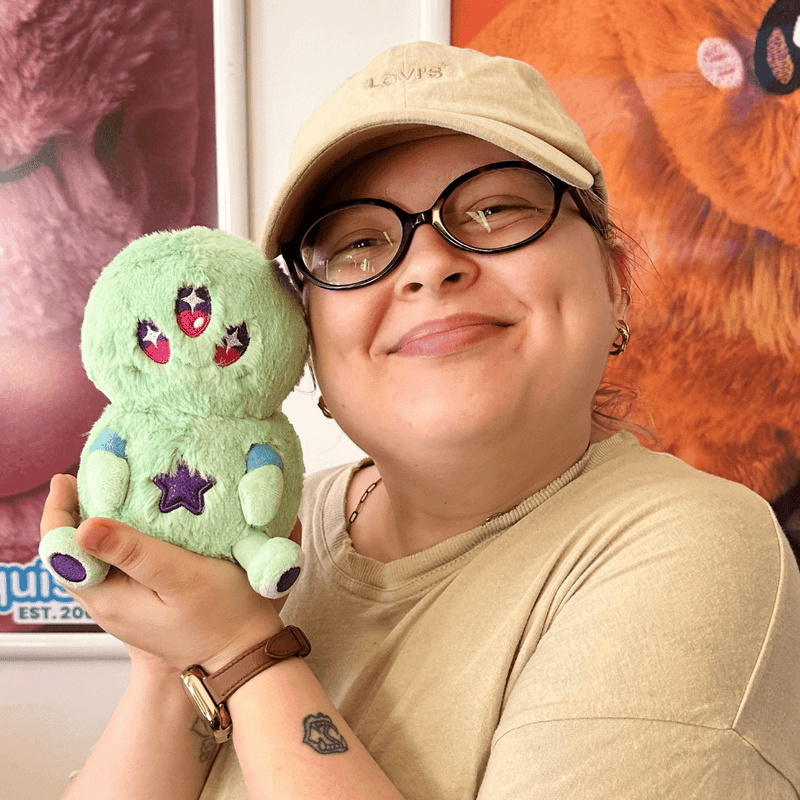 Squishable Snacker Green Alien plush toy being held for size comparison
