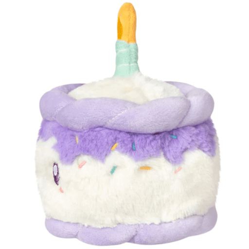 Side view of the Squishable Snacker Happy Birthday Cake soft toy showing lilac frosting and colourful sprinkles
