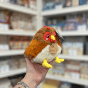 Squishable Snacker Hen plush toy angled view held in hand in a shop