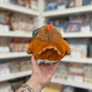 Squishable Snacker Hen plush toy back view held in hand in a shop