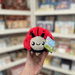 Squishable Snacker Ladybug plush toy held in hand, front view with tag visible