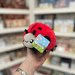 Squishable Snacker Ladybug plush toy held in hand at an angle with tag visible