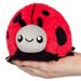 Squishable Snacker Ladybug plush toy sitting in a hand for size reference