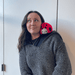 Person wearing Squishable Snacker Ladybug plush toy on shoulder