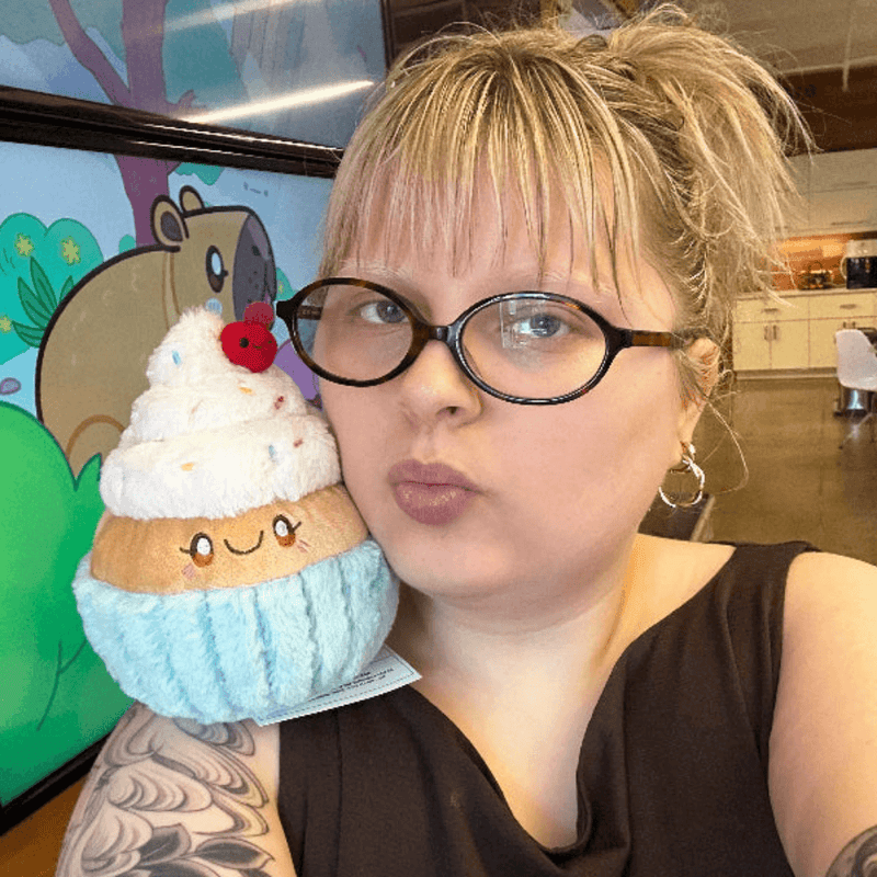 Squishable Snacker Madame Cupcake plush toy being held for size comparison