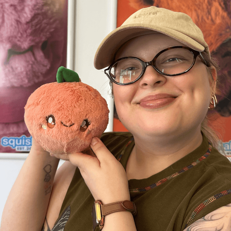 Squishable Snacker Peach plush being held