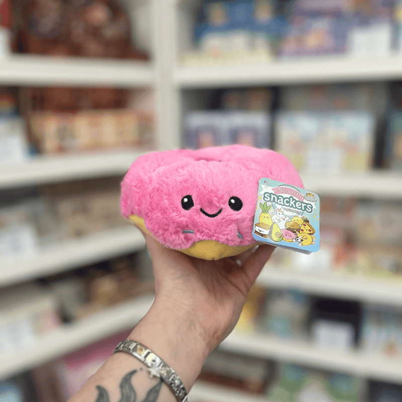 Squishable Snacker Pink Donut plush toy held in hand, front view