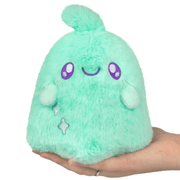 Squishable Snacker Teal Ghost plush with fluffy mint-teal fur, purple embroidered eyes and smiling face