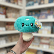Squishable Snacker Turquoise Mushroom plush toy front view held in hand in a shop