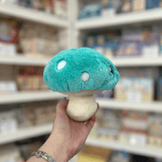 Squishable Snacker Turquoise Mushroom plush toy side back view held in hand in a shop
