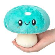 Squishable Snacker Turquoise Mushroom plush toy front view held in a hand
