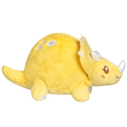 Side view of the yellow Squishable Snacker Triceratops plush showing its tail
