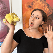 Squishable Snacker Yellow Triceratops plush being held to show its compact size