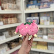 Side view of Squishable Alter Egos Strawberry Kitty plushie with pink strawberry body, yellow paws and cute cat face