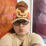 Person posing with the Squishable Alter Egos Takoyaki Spider plush toy