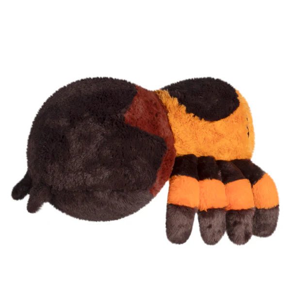 Side profile of the Squishable Tarantula plush highlighting its round body and fluffy legs.