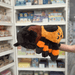 Squishable Tarantula plush toy held in hands in a gift shop, side view