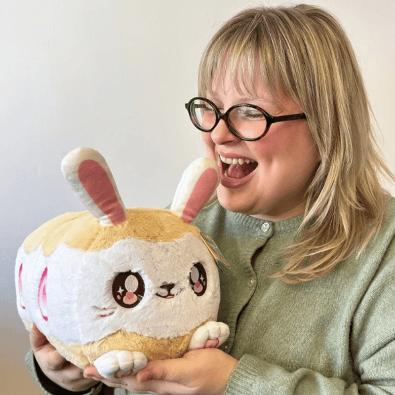 Person holding Squishable Toobling Strawberry Sandwich Bunny plush to show its cuddly size