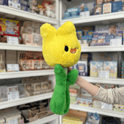 Squishable Tulip plush toy side view held in hand in a shop