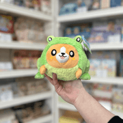 Squishable Undercover Snacker Corgi in Frog plush toy front view held in hand in a shop