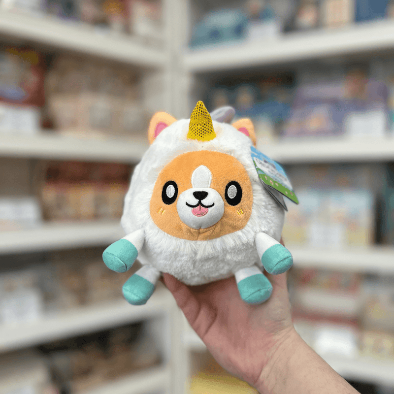Squishable Undercover Snacker Corgi in Unicorn plush toy front view held in hand in a shop
