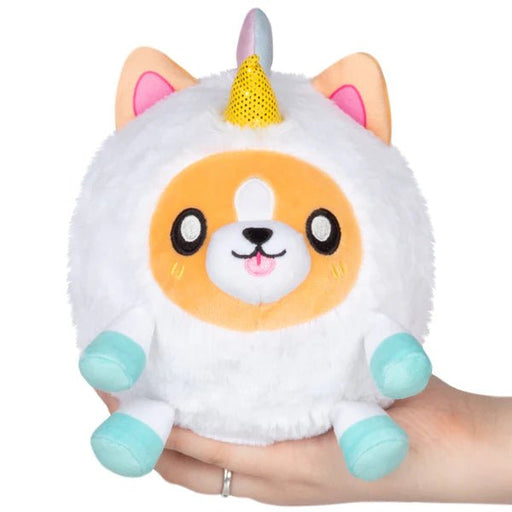 Squishable Undercover Snacker Corgi in Unicorn plush with glitter horn and aqua hooves, held in hand