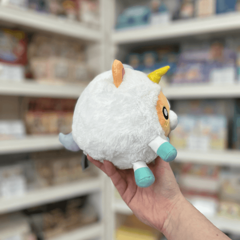 Squishable Undercover Snacker Corgi in Unicorn plush toy side view held in hand in a shop