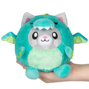 Squishable Undercover Snacker Kitty in Dragon plush in teal with wings and kitty face, held in hand