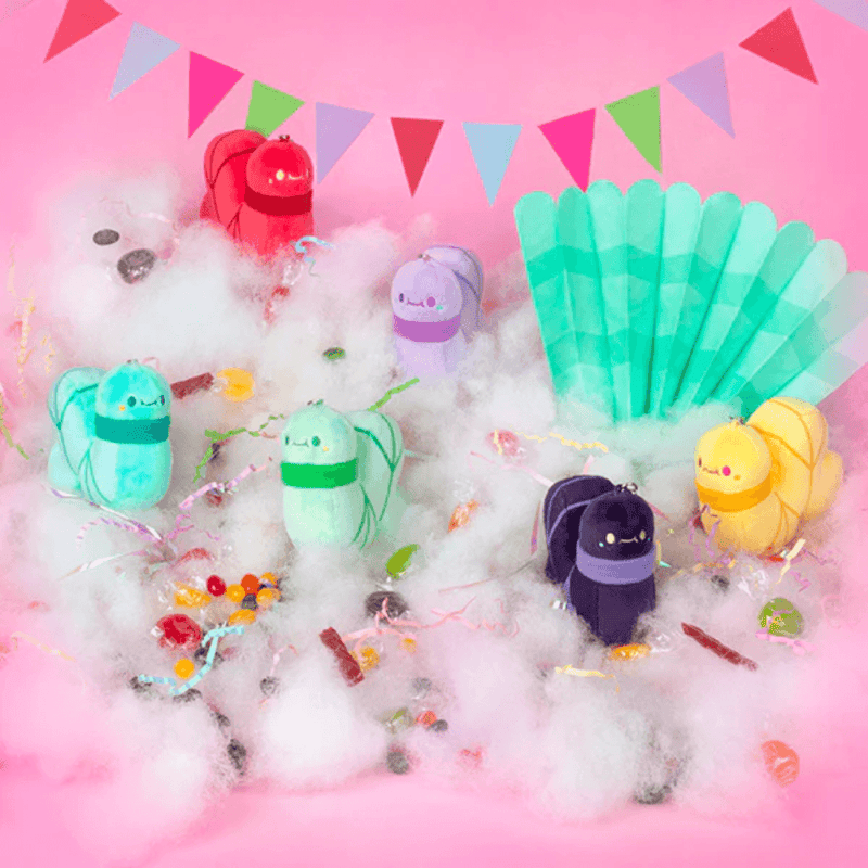 Squishable Candy Shop worm plush keychains displayed among colourful sweets