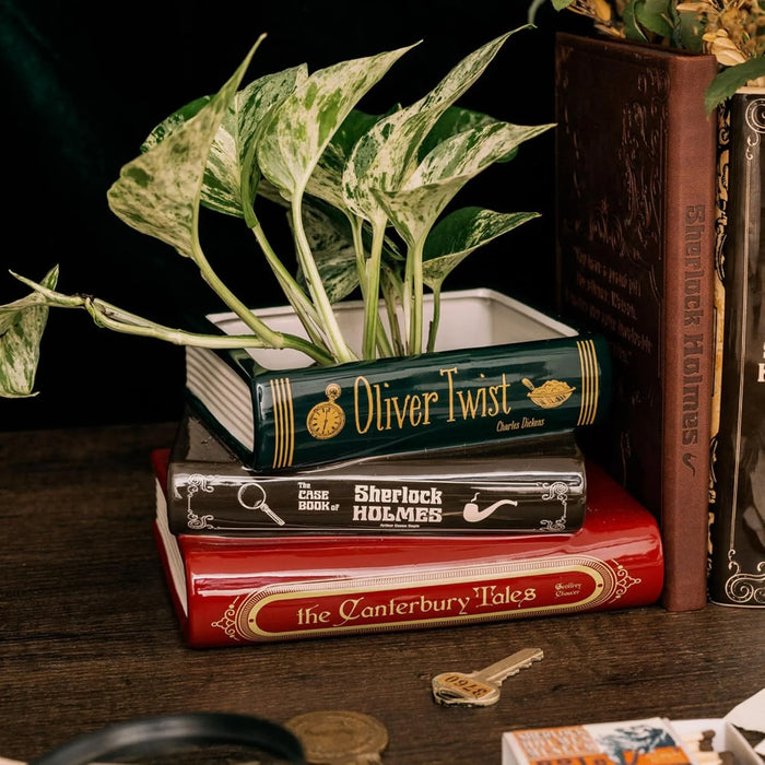 Oliver Twist book planter styled on a desk with trailing plant and Sherlock Holmes décor