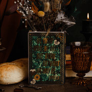 Steel Mill Hamlet book vase styled with dried flowers in a dark literary display
