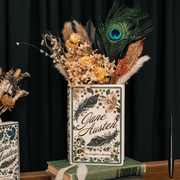 Jane Austen ceramic book vase displayed with dried flowers and a peacock feather