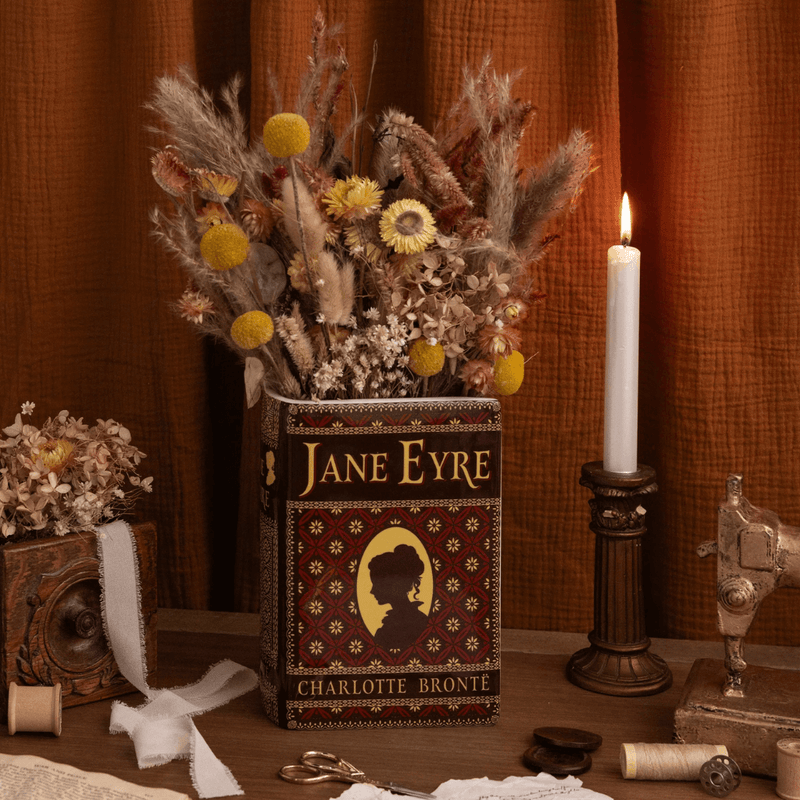 Jane Eyre ceramic book vase displayed with dried flowers and vintage accessories