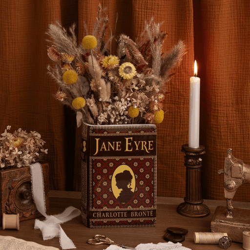 Jane Eyre ceramic book vase displayed with dried flowers and vintage accessories