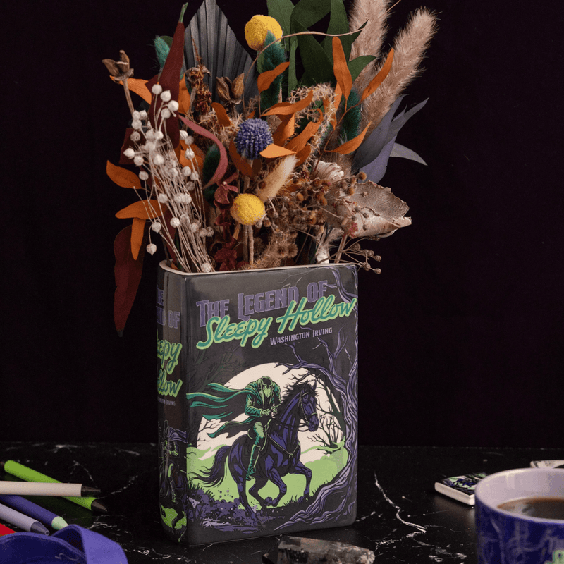 Sleepy Hollow book vase displayed with dried flowers in a dark gothic setting