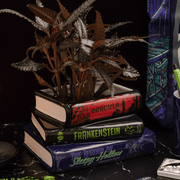 Sleepy Hollow, Frankenstein and Dracula stacked book planter displayed with a houseplant