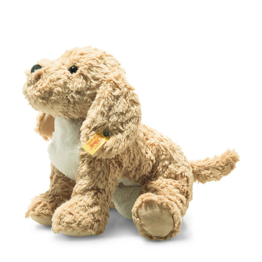 Angled view of Steiff Berno Goldendoodle plush in honey cream with floppy ears and Button in Ear – Steiff teddy bears