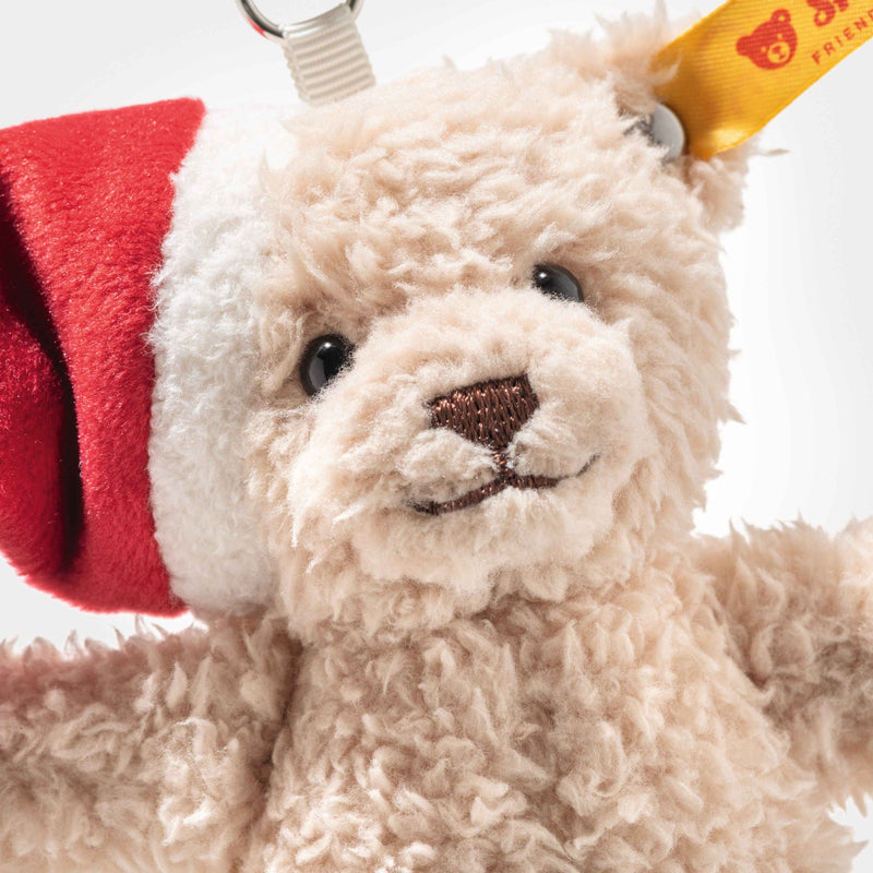 Close-up of Ben teddy bear keyring showing curly beige fur and stitched nose with Steiff ear tag