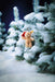 Ben teddy bear keyring hanging on a snow-covered fir tree, festive night scene